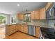 Kitchen featuring stainless steel appliances, light wood cabinets and granite countertops at 311 Arlington Rdg, Cary, NC 27513