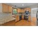 Kitchen featuring granite countertops, stainless steel appliances, and oak wood cabinets at 311 Arlington Rdg, Cary, NC 27513