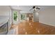 Open-concept living room with hardwood floors and fireplace, flowing into a modern kitchen at 311 Arlington Rdg, Cary, NC 27513