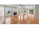 Sunlit living area with a fireplace, large windows, and sliding glass doors to the backyard at 311 Arlington Rdg, Cary, NC 27513
