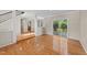 Bright living room with hardwood floors, a staircase, and sliding glass doors to a deck at 311 Arlington Rdg, Cary, NC 27513