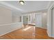 Open-concept living area with hardwood floors and neutral color palette at 311 Arlington Rdg, Cary, NC 27513