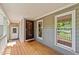 Covered front porch with a wood deck, gray siding, and a view to the neighborhood at 311 Arlington Rdg, Cary, NC 27513