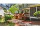 Enjoy the spacious wooden deck with a charming gate and steps to the backyard at 311 Arlington Rdg, Cary, NC 27513