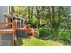 This home features a large wooden deck with steps to the backyard and screened porch at 311 Arlington Rdg, Cary, NC 27513