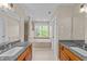 Bathroom featuring double sinks with granite countertops, a soaking tub, and a tiled shower at 311 Arlington Rdg, Cary, NC 27513