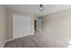 Bedroom featuring carpet, a modern ceiling light, and double door closet at 311 Arlington Rdg, Cary, NC 27513