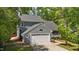 Charming two-story home with attached garage, mature trees, and a concrete driveway at 311 Arlington Rdg, Cary, NC 27513