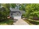 Charming two-story home with attached garage, mature trees, and a concrete driveway at 311 Arlington Rdg, Cary, NC 27513