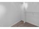 A simple walk-in closet design with metal bars and white walls with tan carpeted floors at 311 Arlington Rdg, Cary, NC 27513