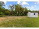 Spacious backyard with storage shed surrounded by lush greenery at 326 W Gilbreath St, Graham, NC 27253