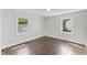 Bright bedroom with hardwood floors and plenty of natural light from two windows at 326 W Gilbreath St, Graham, NC 27253
