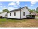 Exterior view of a white house with black trim and a small deck at 326 W Gilbreath St, Graham, NC 27253