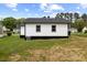 Rear exterior showing siding, windows, and well-maintained yard at 326 W Gilbreath St, Graham, NC 27253