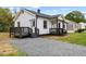 Charming home featuring a covered front porch with dark wood railings and steps at 326 W Gilbreath St, Graham, NC 27253