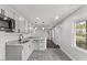 Renovated kitchen features granite countertops, stainless steel appliances, and a view to the front yard at 326 W Gilbreath St, Graham, NC 27253