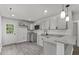 Updated kitchen with gray cabinets, granite countertops, and stainless steel appliances at 326 W Gilbreath St, Graham, NC 27253