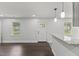 Bright living room featuring hardwood floors, natural light, and modern pendant lighting at 326 W Gilbreath St, Graham, NC 27253
