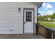 Side entrance with a storm door and a black frame with a small covered porch at 326 W Gilbreath St, Graham, NC 27253