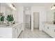 A spacious bathroom with double vanities, white cabinetry and decorative plant at 3297 Oakfields Rd # 1, New Hill, NC 27562