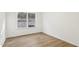 Simple bedroom showcasing hardwood floors and a window view of the exterior at 3297 Oakfields Rd # 1, New Hill, NC 27562