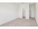A carpeted bedroom with a doorway to a walk-in closet at 3297 Oakfields Rd # 1, New Hill, NC 27562