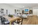 Dining room with a light wood table, stylish chairs, and access to the living area at 3297 Oakfields Rd # 1, New Hill, NC 27562