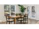 Bright dining area with a modern wood table, chic chairs, and natural light at 3297 Oakfields Rd # 1, New Hill, NC 27562