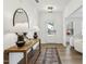 Modern entryway with wooden floors, stylish console table, and decorative mirror at 3297 Oakfields Rd # 1, New Hill, NC 27562