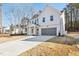 Beautiful two-story home featuring a modern design, long driveway, and attached garage at 3297 Oakfields Rd # 1, New Hill, NC 27562
