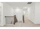 Hallway with carpet flooring, natural wood railing, and white walls at 3297 Oakfields Rd # 1, New Hill, NC 27562