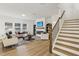 Bright living room featuring a fireplace, built-in shelving, and an adjacent staircase at 3297 Oakfields Rd # 1, New Hill, NC 27562