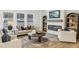 Bright living room featuring a fireplace, TV, large windows, and a comfortable seating area at 3297 Oakfields Rd # 1, New Hill, NC 27562