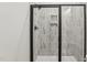 Close up of the shower with black hardware and white marble-style tiling at 3297 Oakfields Rd # 1, New Hill, NC 27562