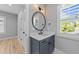 Stylish bathroom features a blue vanity, white quartz countertop, and modern fixtures at 3316 Milton Rd, Raleigh, NC 27609