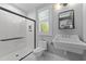 Modern bathroom featuring a walk-in shower, elegant sink, and stylish tile flooring at 3316 Milton Rd, Raleigh, NC 27609