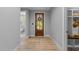 Inviting entryway with hardwood floors and a glimpse of the bathroom at 3316 Milton Rd, Raleigh, NC 27609