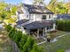 Aerial view of a two-story home with a rear patio and landscaped yard at 3316 Milton Rd, Raleigh, NC 27609