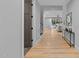 Bright hallway with hardwood floors leading to the living room at 3316 Milton Rd, Raleigh, NC 27609