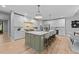 Spacious kitchen with a large island, modern appliances, and stylish white and green cabinetry at 3316 Milton Rd, Raleigh, NC 27609