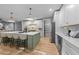 Open kitchen featuring a large island with seating and stainless steel appliances at 3316 Milton Rd, Raleigh, NC 27609