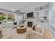 Cozy living room with a fireplace, built-in shelving, and access to the backyard at 3316 Milton Rd, Raleigh, NC 27609