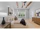 Bright main bedroom with tray ceiling, exposed wood beams, accent wall and large windows at 3316 Milton Rd, Raleigh, NC 27609