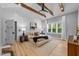 Bright main bedroom with tray ceiling, exposed wood beams, accent wall and large windows at 3316 Milton Rd, Raleigh, NC 27609