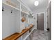 Well-organized mudroom with custom shelving, a bench, and stylish tile flooring at 3316 Milton Rd, Raleigh, NC 27609