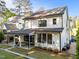 Exterior rear of a two-story home showcasing a covered patio and well-maintained landscaping for optimal outdoor enjoyment at 3316 Milton Rd, Raleigh, NC 27609