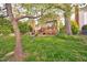 Spacious backyard featuring a charming deck, a swing set, and mature trees at 3517 Elk St, Burlington, NC 27215