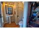 Charming half-bathroom featuring a pedestal sink, decorative mirror, and vintage-inspired decor at 3517 Elk St, Burlington, NC 27215