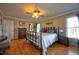 Bedroom with an elegant bed, wood floors, modern ceiling fan, and ample natural light at 3517 Elk St, Burlington, NC 27215