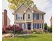 Charming two-story home with brick and siding, dark shutters, and a landscaped front yard at 3517 Elk St, Burlington, NC 27215